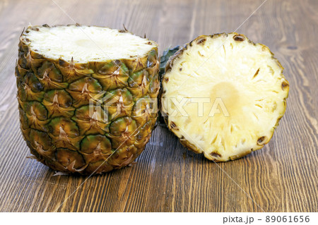 cut into pieces ripe yellow pineapple on the table 89061656