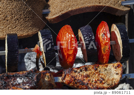 barbecue with cooking fresh eggplant on the fire 89061711