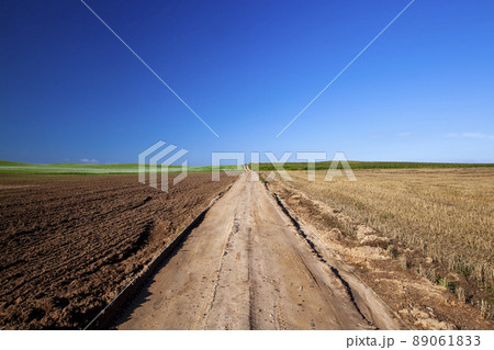 empty, paved road in the countryside in the form of a track from the wheels of cars 89061833