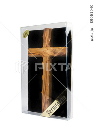 Wooden crucifix standing in box on white background 89061940