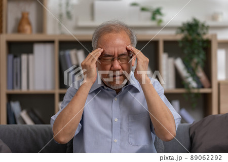 Asian elderly seniority man got headache and migraine. Old man got pain and illness on couch alone at home. Thoughtful, stressed out and loneliness made depression and bad mental health. Asian elderly seniority man got headache and migraine. Old man got pain and illness on couch alone at home. Thoughtful, stressed out and loneliness made depression and bad mental health. 89062292