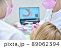 Female patient having dental scanning done by her dentist 89062394