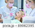 Dentist and assistant scaning patient's teeth with   intraoral 3d scanner. 89062395