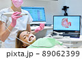 Woman having her teeth 3d scanned by professional dentist. 89062399
