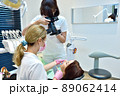 Woman dentist taking pictures of teeth before teeth whitening procedure. 89062414