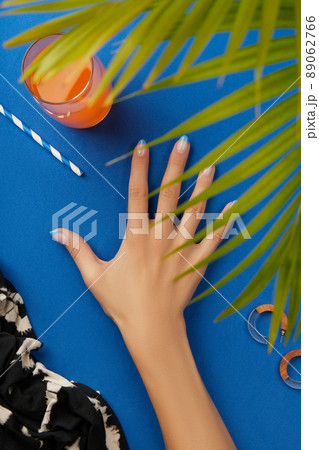 Manicured womans hand with summer clothes and accessories 89062766