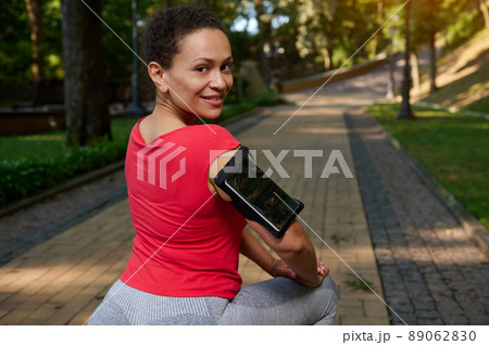 Charming middle aged active woman in tight sportswear exercising outdoor. Sport, fitness, active lifestyle concept 89062830