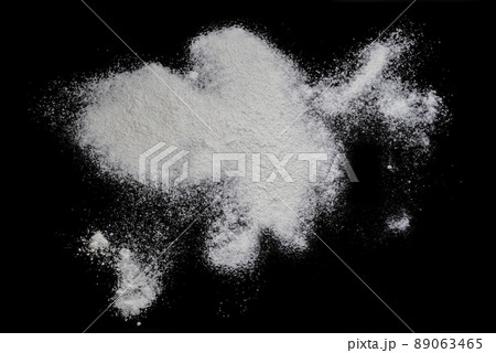 Black background sprinkled with flour, smeared flour, table for cooking, rolling dough. Preparing for baking, top view on a black background or table. Preparation of dough or dough. 89063465