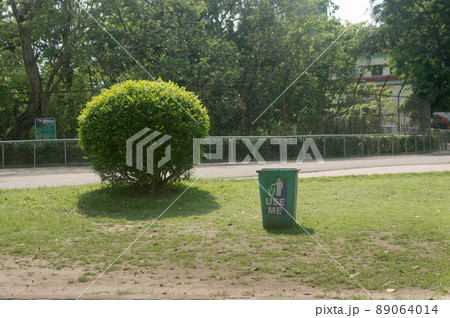 An use me dustbin in the public garden. An use me dustbin in the public garden. 89064014