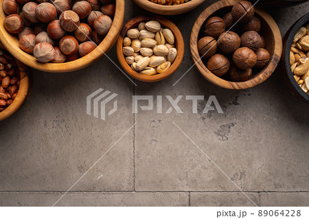 Assortment of nuts in bowls Assortment of nuts in bowls 89064228