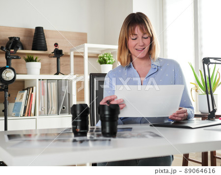 Female photographer working at office studio Female photographer working at office studio 89064616