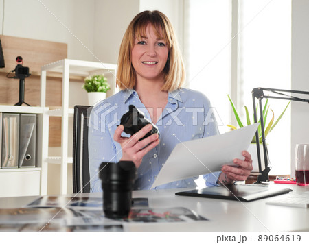 Female photographer working at office studio Female photographer working at office studio 89064619