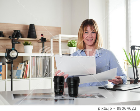Female photographer working at office studio 89064622