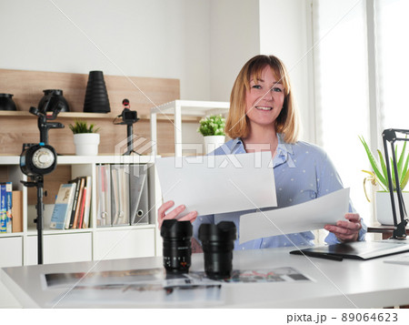 Female photographer working at office studio Female photographer working at office studio 89064623