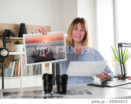 Female photographer working at office studio Female photographer working at office studio 89064625