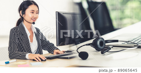 Business people wearing headset working in office broaden view Business people wearing headset working in office broaden view 89065645