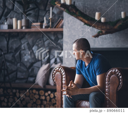 Adult man in blue t-shirt at home 89066011