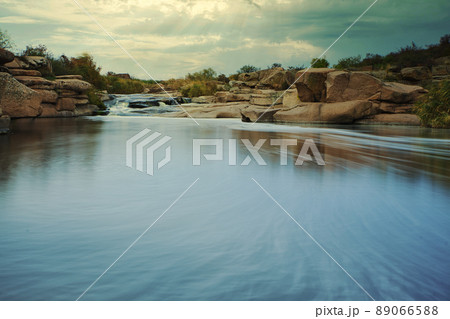 Beautiful mountain river flowing over rocks. Flow of water in mountain river close up Beautiful mountain river flowing over rocks. Flow of water in mountain river close up 89066588