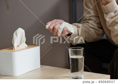 Horizontal close-up of unrecognizable man suffering depression having psychologist appointment siiting at table with glass of water Horizontal close-up of unrecognizable man suffering depression having psychologist appointment siiting at table with glass of water 89068937
