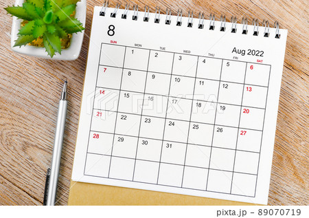August 2022 desk calendar with pen on wooden table. August 2022 desk calendar with pen on wooden table. 89070719