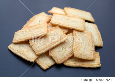 Cheese crispies on dark background. Cheese crispies on dark background. 89071921