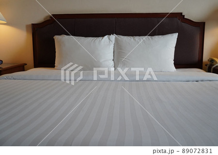 Towels and bedding on double beds in dormitories or guesthouse rooms that are empty. 89072831