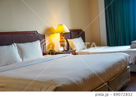 Towels and bedding on double beds in dormitories or guesthouse rooms that are empty. 89072832