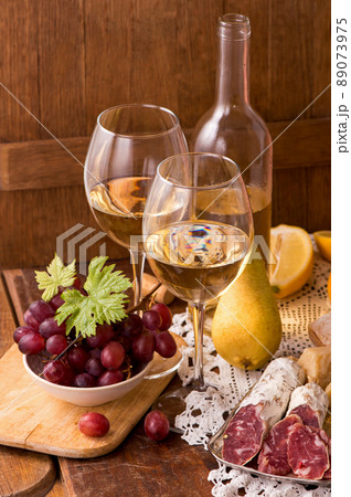 white wine and fruits. Wine and grapes in vintage setting on wooden table white wine and fruits. Wine and grapes in vintage setting on wooden table 89073975