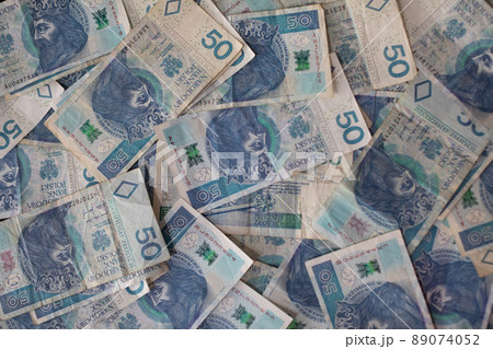 Many randomly scattered paper bills with the face value of fifty Polish zloty. 89074052