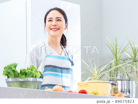 キッチンで料理をする主婦 89075823