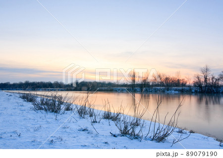 Beautiful winter landscape with frozen lake and sunset sky. Composition of nature. Beautiful winter landscape with frozen lake and sunset sky. Composition of nature. 89079190