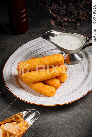 Closeup on fried breaded cheese sticks 89079516