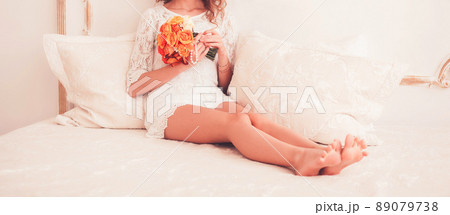 young woman sitting with a bouquet young woman sitting with a bouquet 89079738