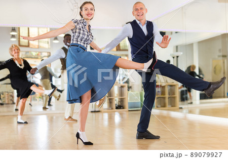 Man and woman performing jazz dance in dancing room 89079927