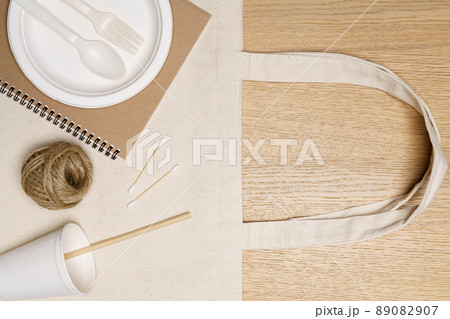 Eco friendly concept, Eco bag with notebook food container and jute rope on wooden background Eco friendly concept, Eco bag with notebook food container and jute rope on wooden background 89082907