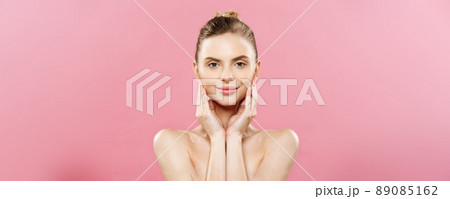 Beauty Concept - Beautiful Woman with Clean Fresh Skin close up on pink studio. Skin care face. Cosmetology. 89085162
