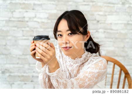 コーヒーを飲んでくつろぐ女性 コーヒーを飲んでくつろぐ女性 89086182
