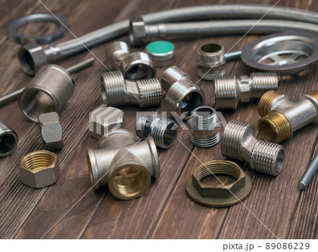 Set of the plumbing equipment on a wooden table. 89086229