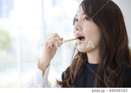 竹歯ブラシで歯磨きをする女性 89088165