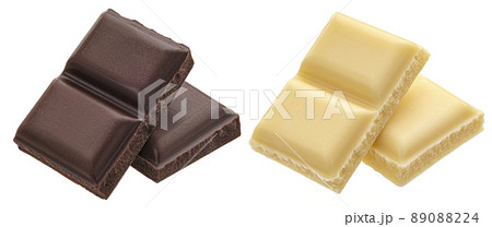 Dark and white milk chocolate pieces isolated, full depth of field 89088224