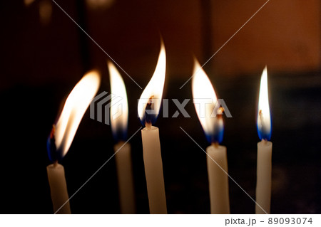 Fire of candles on christmas background.  Candles burning at night. 89093074