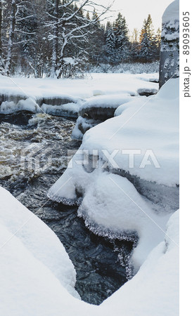 Water flow of a small snow-covered forest river, ice fragments close-up. Long exposure. Global warming concept, ecology, environmental conservation, graphic resources, macro photography Water flow of a small snow-covered forest river, ice fragments close-up. Long exposure. Global warming concept, ecology, environmental conservation, graphic resources, macro photography 89093605