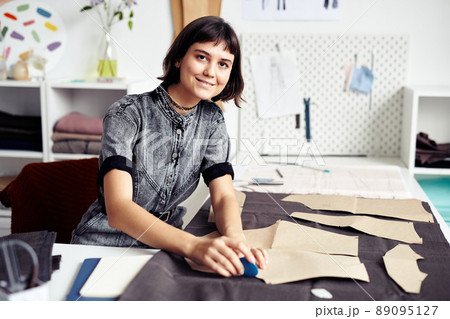 Seamstress Cutting out Garment Details Seamstress Cutting out Garment Details 89095127