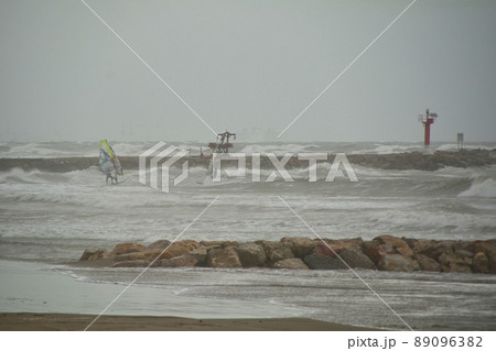 People windsurfing on a stormy day 89096382