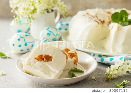 Pannacotta dessert. Cottage cheese souffle Panna cotta with apricots on a stone or slate on a light countertop. 89097152