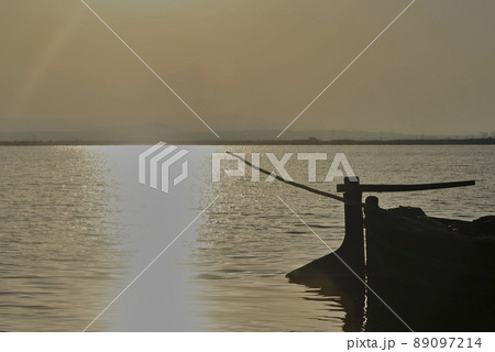 Back of a small boat on a lake. silhouettes 89097214