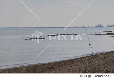 Fishing rods on the shore of the beach 89097241