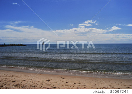 Sailboat sailing through the sea on a bright day 89097242