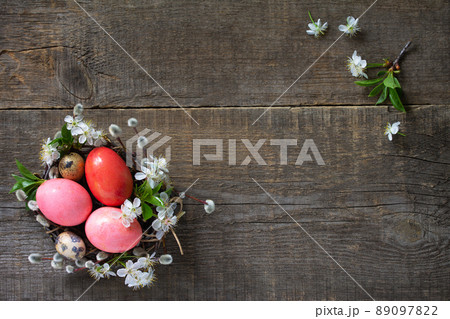 Easter background with  Pink handmade Easter eggs and spring flowers. Top view flat lay background. Copy space. 89097822