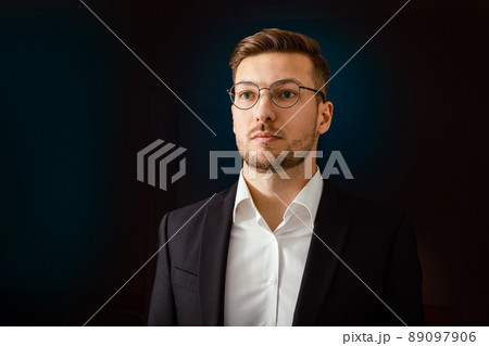 Portrait of a businessman in a suit on a dark background. Portrait of a businessman in a suit on a dark background. 89097906